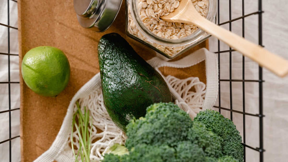 A collection of fresh ingredients including avocado, broccoli, and oats for a nutritious meal prep.